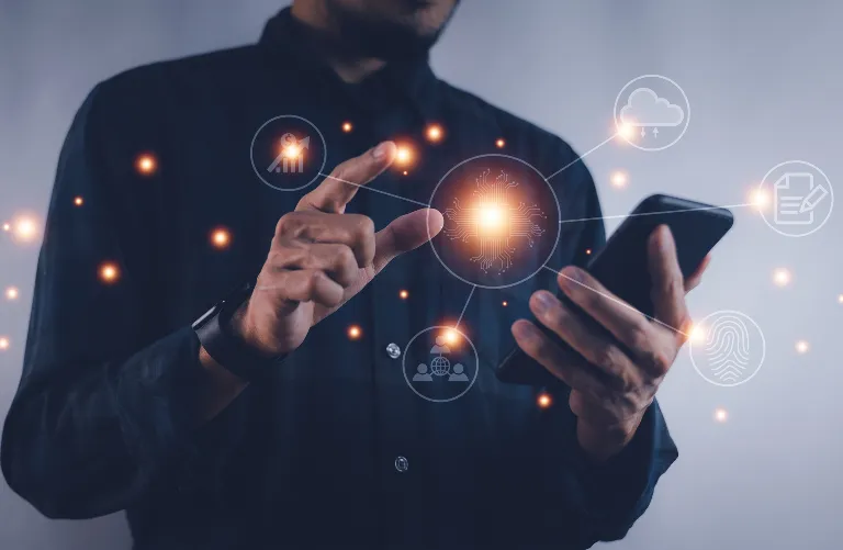 Main touchant l'écran d'un smartphone entouré d'icônes flottantes représentant le cloud, la sécurité, les réseaux sociaux, et la technologie, promus par Madagasy.com pour encourager l'innovation numérique à Madagascar.
